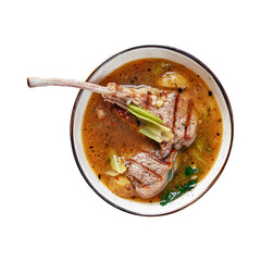 Portion of soup with lamb ribs celery and spinach