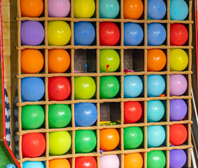 Balloon attraction in the amusement park, Balloon dart toss carnival skill game series, Flying darts arrow pierces a colorful balloon, attraction with colorful balloons in the park