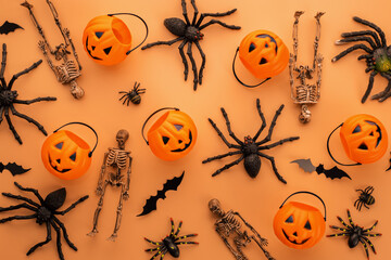Halloween decorations, pumpkins, skeletons, bats, spiders on orange background
