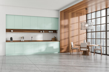 Stylish kitchen interior with eating table and seats, panoramic window