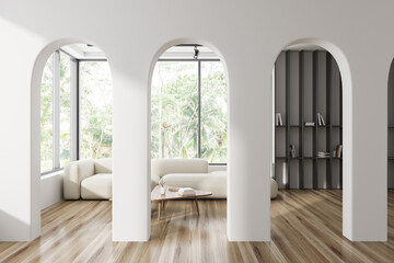 Light meeting room interior with couch and shelf with books, panoramic window