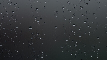 Real background of rain hitting glass with protective coating