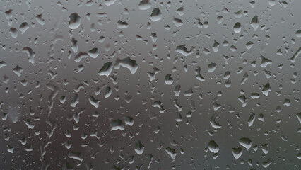 Real background of rain hitting glass window