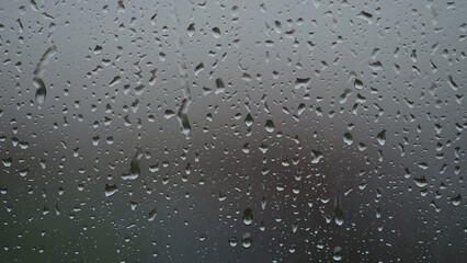 Real background of rain hitting glass window