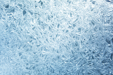 The texture of the ice surface. Winter background, festive background in the form of ice crystals, in natural deep blue color.