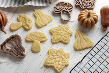 Baking cookies in the form of pumpkin and leaves