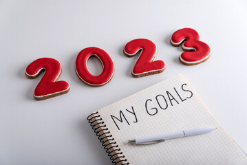 Notebook with inscription My goals, pen and numbers 2023 on white background. Close up