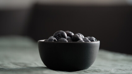 Fresh blueberries in bowl on linen napkin