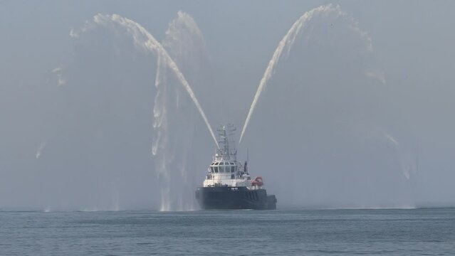 Rescue tugboat at Baltic sea. Water splash. Fire ship