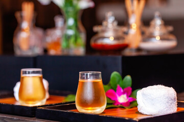 Herbal spa tea in a glass cups with small refreshment towels