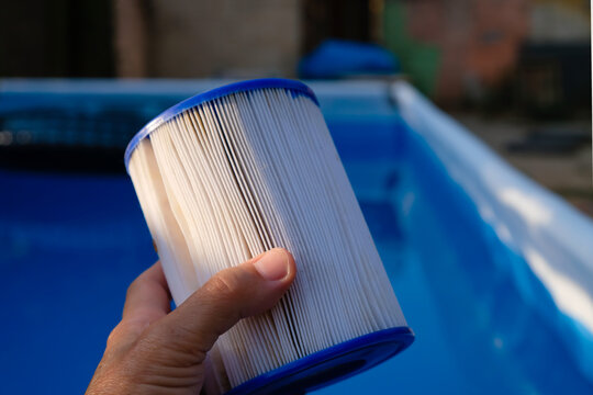 Replacement Pool Filter Cartridge in a woman's hand. Filter reuse. 