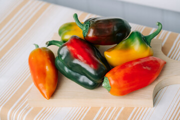 Bell Peppers. Fresh pepper vegetables on wooden cutting board.