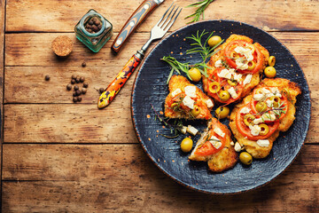 Schnitzel with olives and tomato