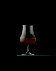 Isolated glass of whiskey, rum or brandy. copy space