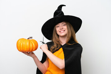 Young pretty woman costume as witch holding a pumpkin isolated on white background celebrating a victory