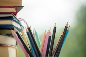 Object education green nature background with stack of ancient books or old bible, open paper book on wooden table with copy space. concept of back to school, research study