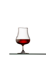 Isolated glass of whiskey, rum or brandy. copy space