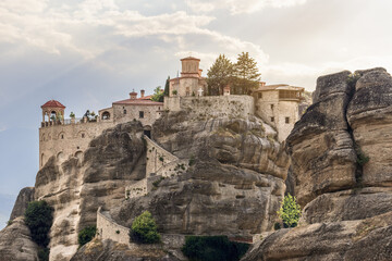Fototapeta na wymiar The tourists have to walk up 140 steps of this curly stairway cut into the solid rock to explore the medieval architectural masterpiece - The Holy St. Varlaam Monastery in Meteora, Greece