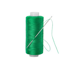 Spool of green sewing thread with needle isolated on white