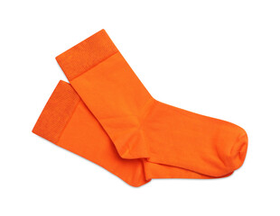 Pair of orange socks on white background, top view