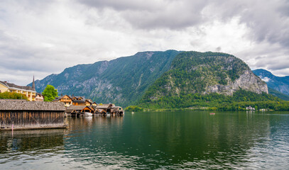 Fototapeta premium Hallstatt dock at the Hallstatter see lake. Big mountains in background.