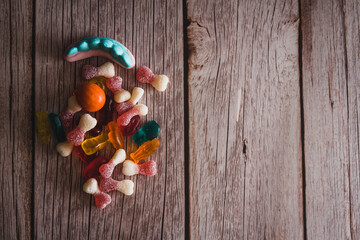 Halloween candy on wooden background. Selective focus. Copy space.