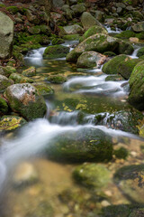 Naklejka na ściany i meble Mountain stream with stones with clear water