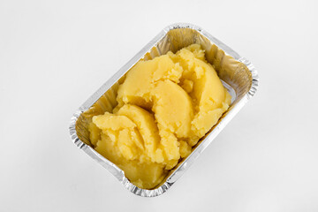 Mashed potatoes served in aluminium tray isolated on white background