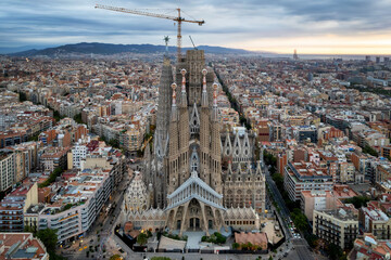 Sunrise drone aerial of the Basilica Sagrada Familia, the iconic church that has been in...