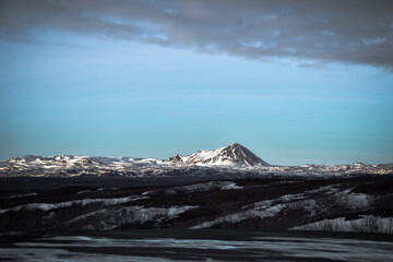 Snow covered sunny winter mountain landscape in Iceland