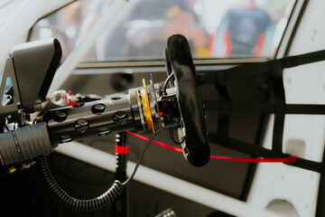 Close up of racing car steering wheel cockpit equipment