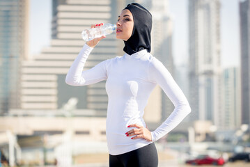 Arabian woman with typical muslim dress training outdoors in Dubai - Middle-eastern beautiful...