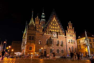 Wroclaw central market square with old houses, town hall and sunset. Panoramic night view, long exposure. Historical capital of Silesia, Wroclaw (Breslau), Poland, Europe.