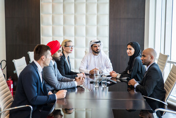Multiracial corporare business team meeting for a deal in Dubai - Multicultural business people having a business meeting - obrazy, fototapety, plakaty