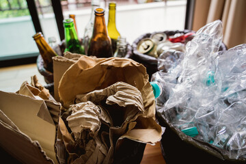 The four different container for sorting plastic, paper, metal and glass waste