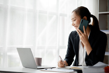 Beautiful Asian woman executives, business executives, marketing executives are talking on the...