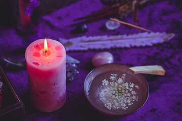 Candle burns on the altar, powerful magic among candles, energy cleaning and wicca concept	