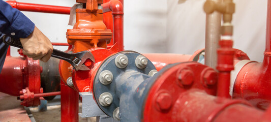 Plumber repairing and performing maintenance big water pipes.