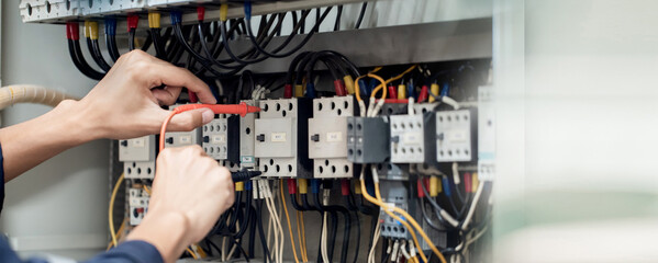 Electrician engineer work tester measuring voltage and current of power electric line in electrical...