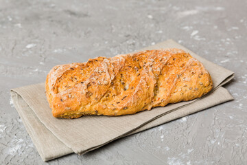 freshly baked bread with napkin on rustic table top view. Healthy white bread loaf isolated
