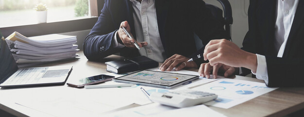 Asian business adviser meeting to analyze and discuss the situation on the financial report in the...