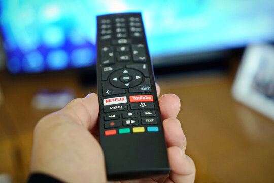 Smart Tv remote control in hand. Milan, Italy - September 2022