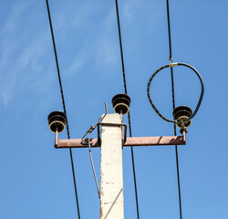 Electric cable on a pole against the sky