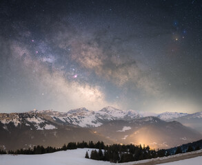 milky way above the mountain during the winter season. mountains with snow, cold weather