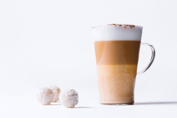 Milk coffee or latte macchiato glass, on white background. Italian coffee with milk and layers. Gourmet coffee.
