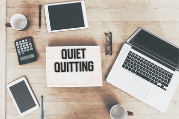 Quiet Quitting message text in vintage style light box on office deskt op