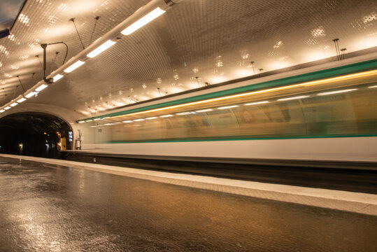 Paris, France. August 2022. A subway station with a passing train in Paris.