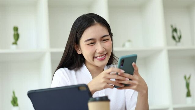 young businesswoman looking at financial information from a mobile phone, she is checking company financial documents, she is a female executive of a startup company. Concept of financial management.