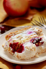 A slice of layer cake with red berries.