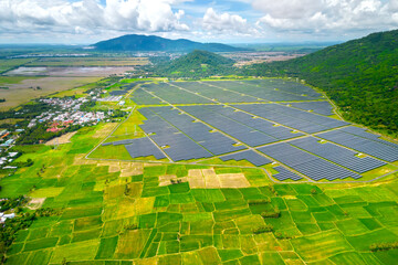 Rice fields interspersed with solar power fields in the morning, a combination of agriculture and...